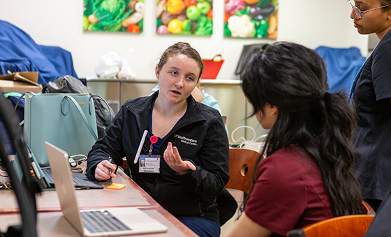 Two SRFC students sitting at a desk discussing research